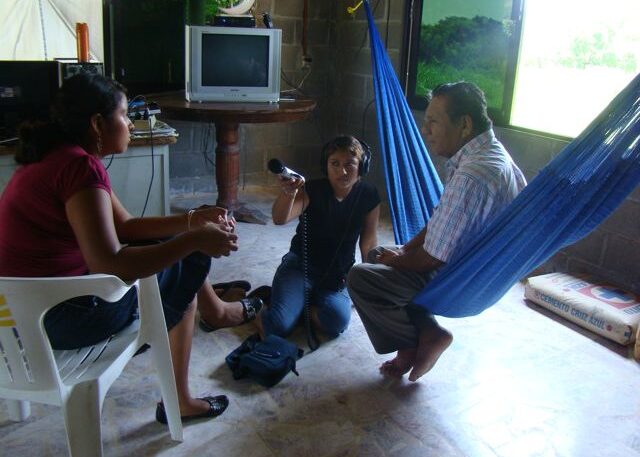 Two young female broadcasters conducting an interview in Oaxaca