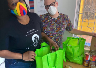 Outright International participants wearing masks and packing grocery bags