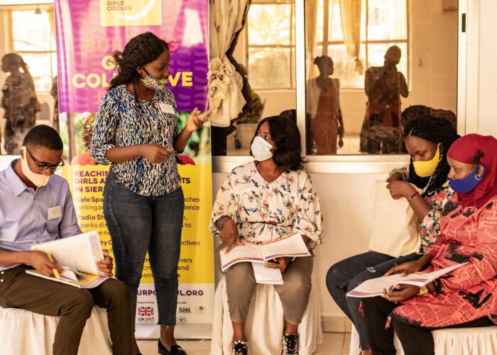 Group of four individuals wearing protective masks being taught in a Purposeful development session
