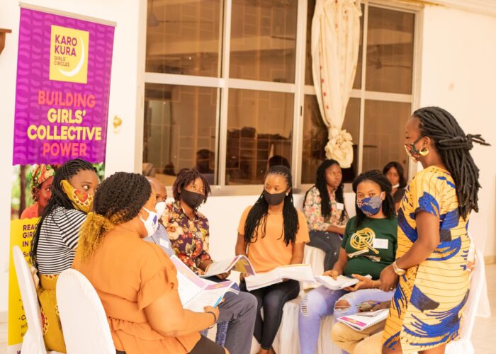 Circle of young women in protective masks being led in development sessions by Purposeful