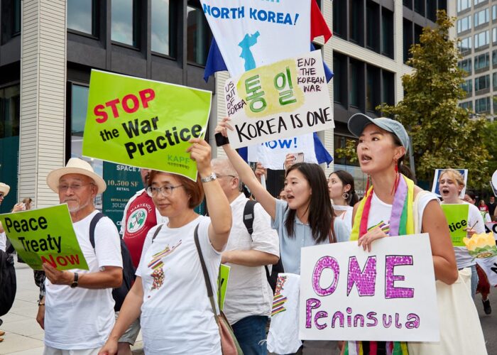 group of Koreans marching with posters