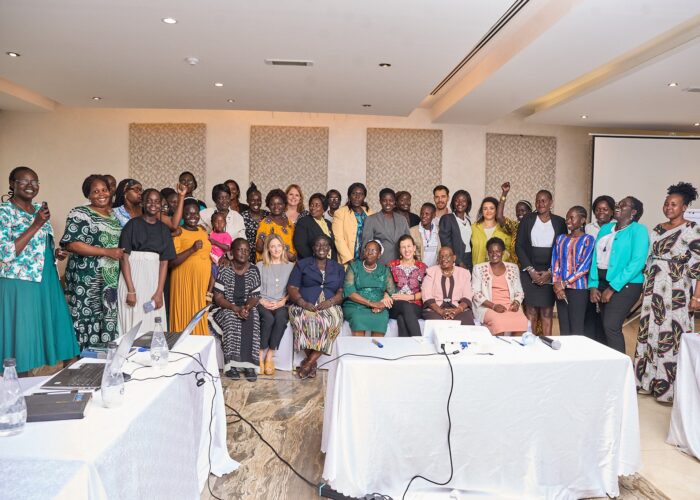 large group of people posing for photo behind set of tables
