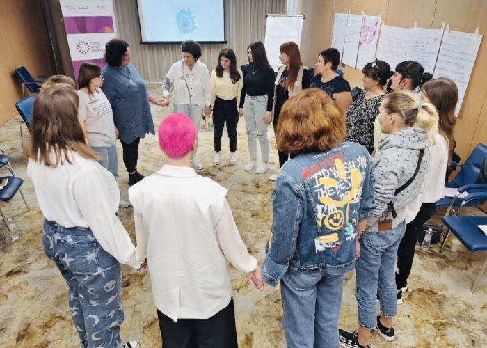 UWF participants holding hands in a circle