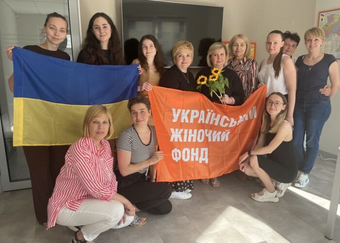 UWF participants holding the Ukrainian flag and a banner