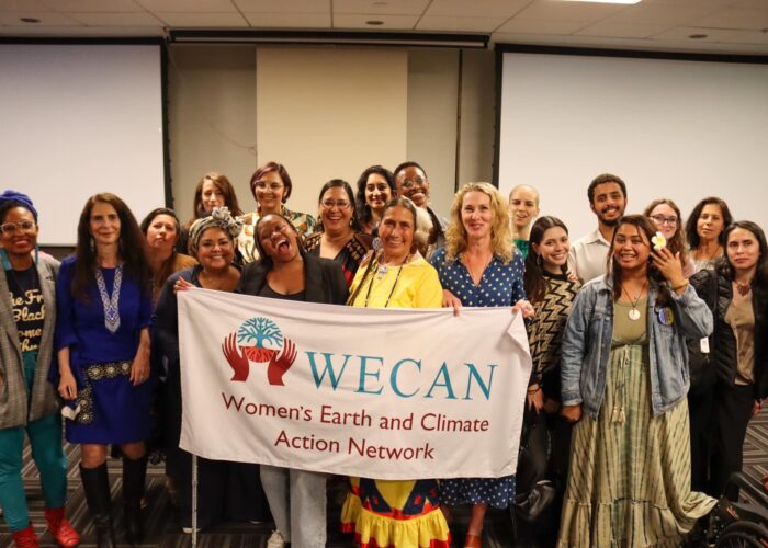 WECAN participants holding a WECAN logo banner