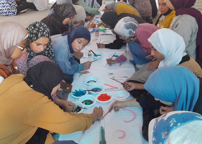 Group of women and children painting in Gaza