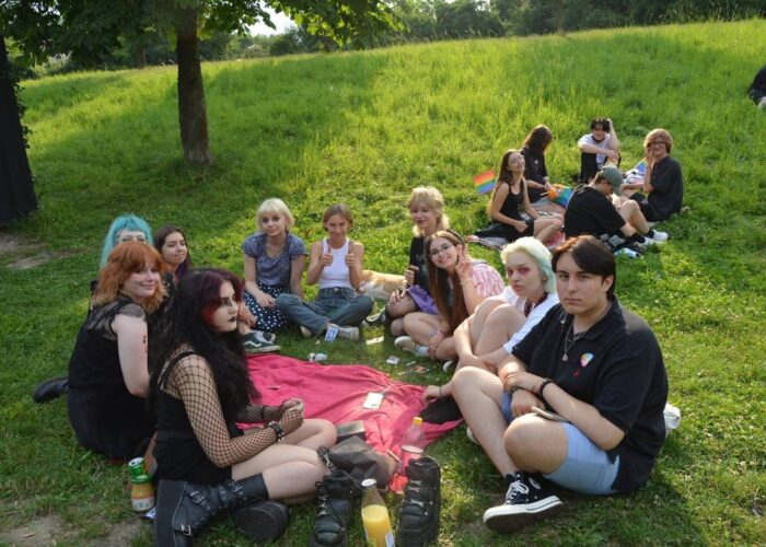 Youth sitting in grass at an Equality March organized by Equality Province and funded by FemFund