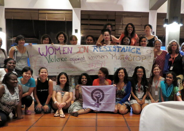DAWN participants holding a handmade Women in Resistance banner