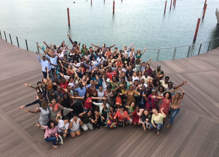 Arial photo of Inroads members, staff, and steering committee standing on the dock in Mombasa