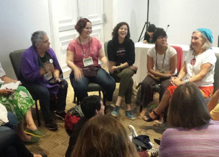 Women at Breaking Silos RESURJ smiling and talking