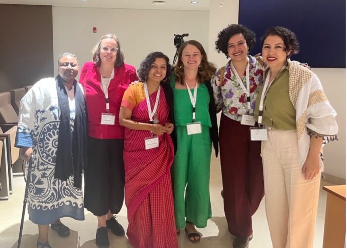 AFM page 3 Women meet at a conference.