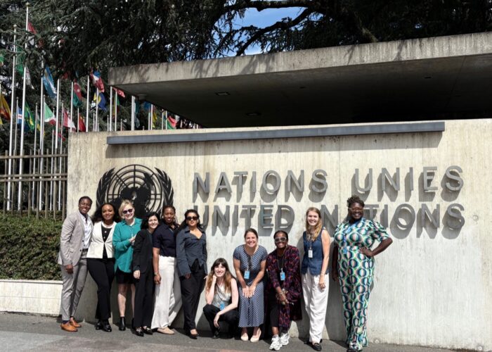 Women stand in front of United Nations Sign