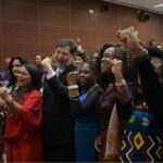 Group of women representatives stand together.