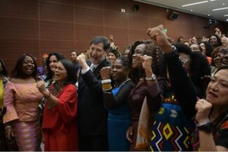 Group of women representatives stand together.