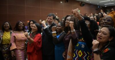 Group of women representatives stand together.