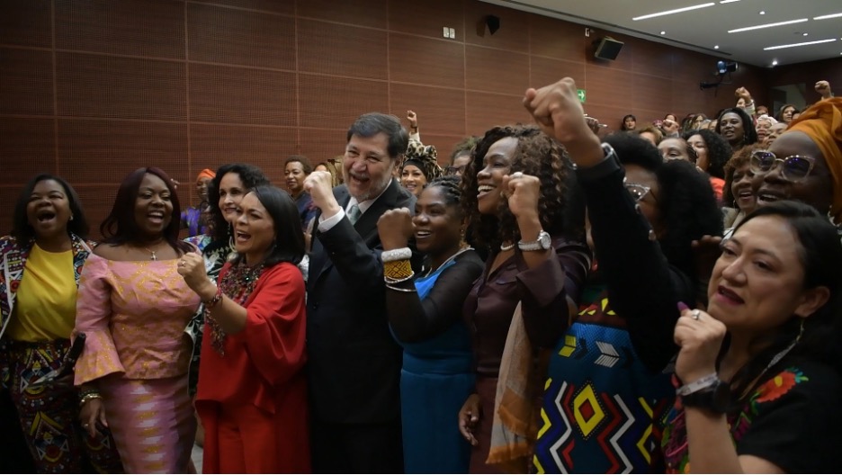 Group of women representatives stand together.