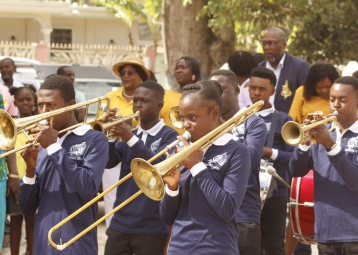 A parade of Haitian youth playing trombones and other instruments