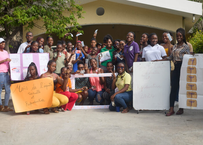 HWC holds up signs for sexual health and reproductive equity month