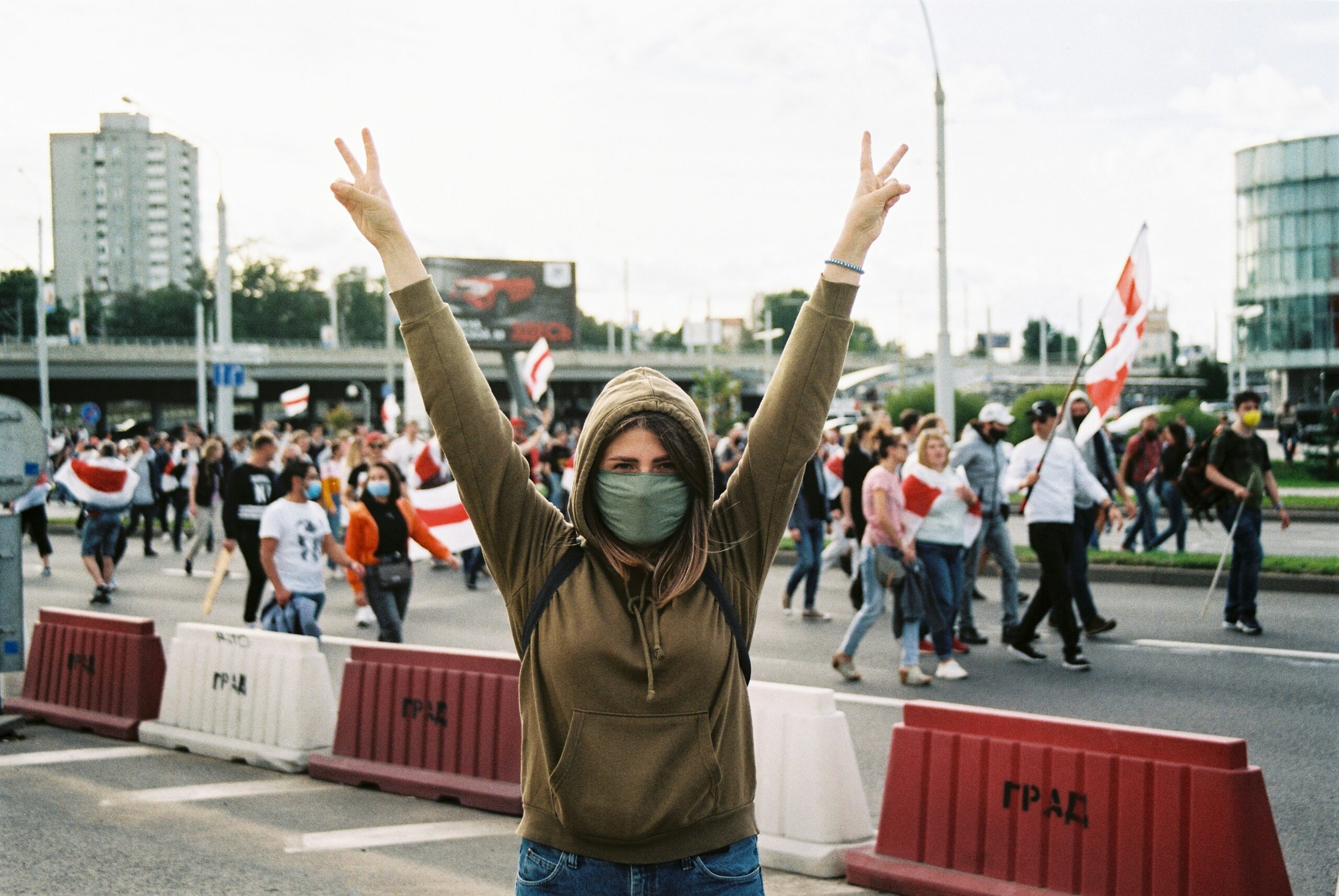 Woman protestor holds up symbols for peace